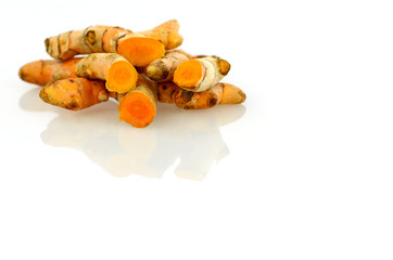 Turmeric roots on white background.