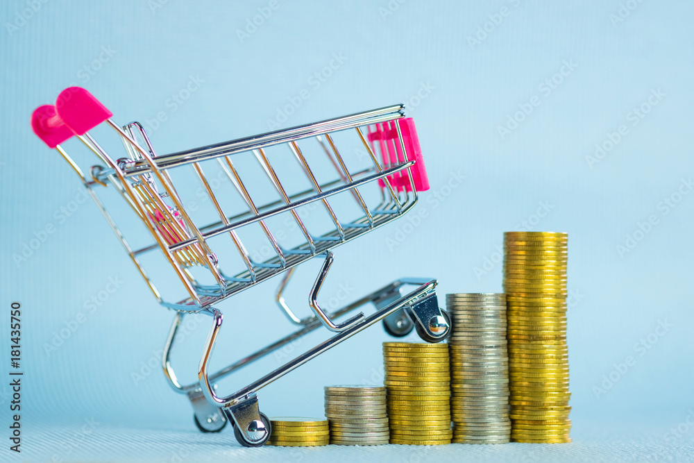 Wall mural step of stacks of coins and shopping cart or supermarket trolley, business finance concept.