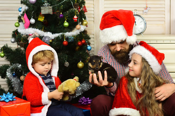 Christmas happy children and father with puppy.