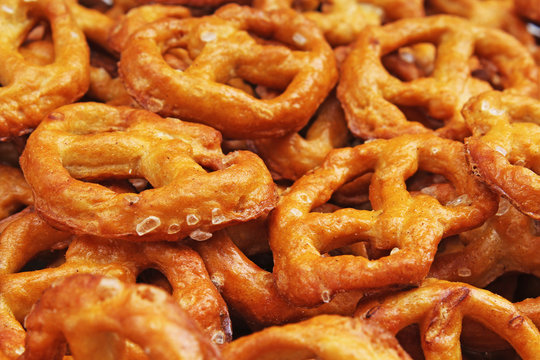 Pretzel shaped bread sticks cracker texture pattern. Salted pretzels. Mini pretzel texture pattern closeup. Bakery photo, Snacks.