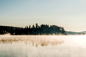 Fototapeta premium Lake of two rivers algonquin national park ontario canada sunset sunrise with fog foggy mystical atmosphere background