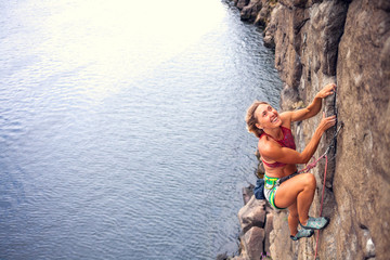 Fototapeta premium girl climbs the rock