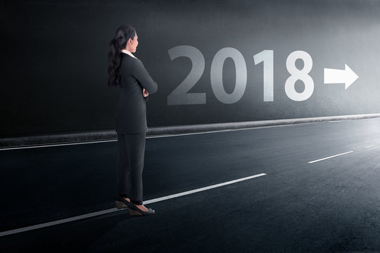 Back view asian business woman standing with a 2018 sign