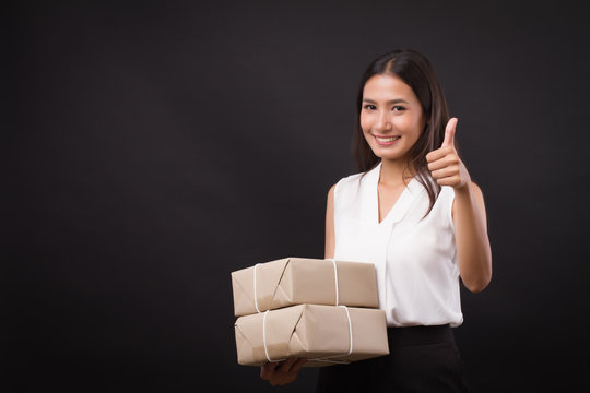 Woman Holding Parcel Box, Pointing Thumb Up