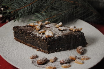 Poppy cake on a white plate. New Year's presentation of dessert. Pastry from confectionery poppy in home conditions