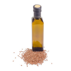 Dark gllass bottle of linseed oil and pile of linseed