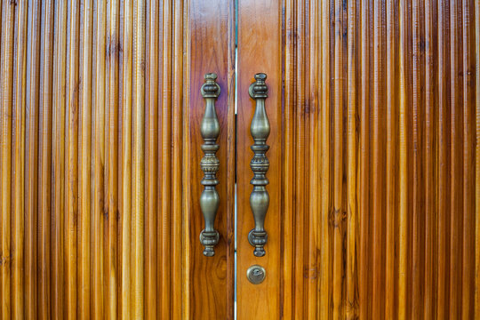 Brass handles of wooden door
