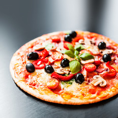 Hot pizza with Pepperoni Sausage on a dark background  with copy space. Cheese Pizza .