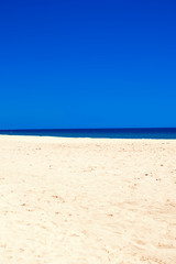 Fototapeta premium Sea Beach and Soft wave of blue ocean. Summer day and sandy beach background.