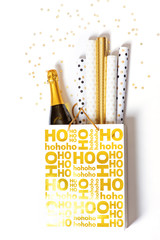 Shopping bag with wrapping paper and bottle of champagne