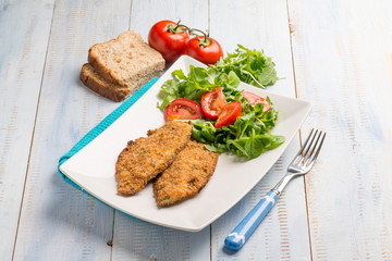 breaded fish fillet with salad