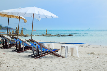 Sun loungers and beach umbrellas on the beach At Koh Samet Thailand.
