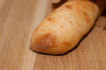 Ciabatta lies on a wooden table