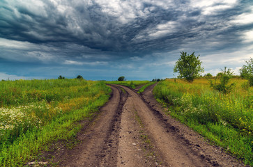 Fototapeta na wymiar rural landscape with road and a stormy sky