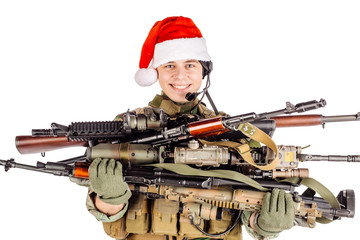 soldier with rifle wearing Santa claus cup and holding cardbox isolated on white background