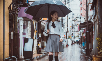 Beautiful japanese girl walking in Tokyo. Concept about teenagers and school