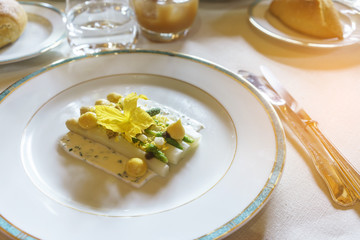Delicious white asparagus with mimosa egg and goat cheese for starter