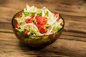 Fresh vegetable salad on wooden table