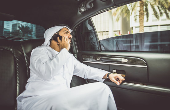 Business man sheik in his limousine talking about trades