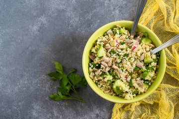 Bowl with couscous, cucumber, parsley and sunflower seeds