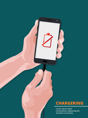 Man holding smartphone with picture on screen of low battery charge