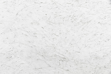 White stucco coarse facade wall made of natural cement as an empty rustic background texture space.
