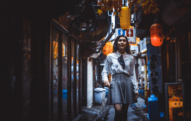 Fototapeta na wymiar Beautiful japanese girl walking in Tokyo. Concept about teenagers and school