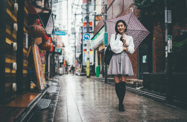 Obraz na płótnie Canvas Beautiful japanese girl walking in Tokyo. Concept about teenagers and school
