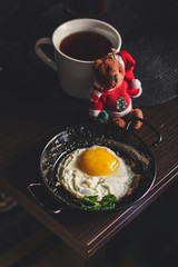 fried eggs with mushrooms for breakfast and a mug of tea