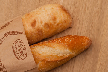 ciabatta and French loaf in a paper bag