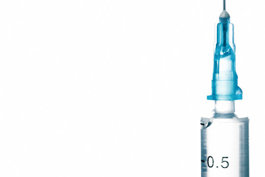Close-up of medical syringe isolated on white background.