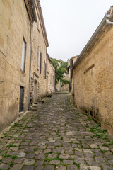 Fototapeta na wymiar ancient street made of stone named Rue de la Port Saint-Martin, in Saint-Emilion, France