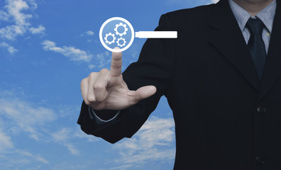 Businessman pressing seo flat icon over blue sky with white clouds, Search engine optimization concept