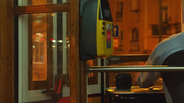 Ultra close-up passenger view of a driver of the famous Eletrico 28 - Tram no. 28 - negotiating night traffic in Lisbon, Portugal. Tram 28 crosses the most important Lisbon sites.