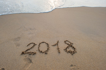 2018 sign on sandy beach