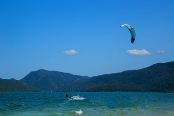 Kitesurfing on Walchensee with beautiful view towards the Bavarian Alps in Germany