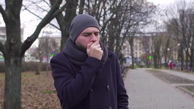 A man coughs in the street, slow-motion shooting