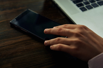 Office, work, hand holds phone, laptop, desktop