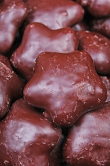 Gingerbread. Chocolate coated gingerbreads as background. Flower shaped gingerbread texture pattern. Cake texture. Cake background photo,.