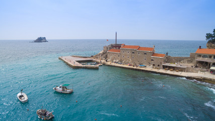 pier, house with  red roof, sea and boats aerial view