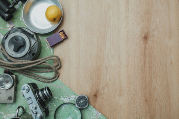 Camping, tourist equipment on the wooden background. Planning a trip