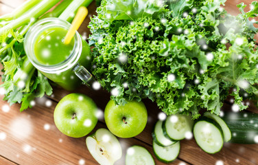 close up of jug with green juice and vegetables