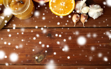 honey, citrus fruits, ginger and garlic on wood