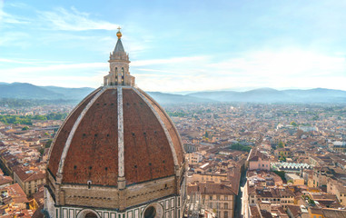 Fototapeta na wymiar Florence city view with duomo dome and cityscape and mountains on horizon