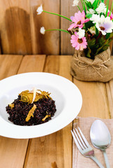 Riceberry Rice topped with curry Powder pork ribs With a simple table, looked comfortable warmth.