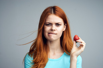 Strawberry, sweetness, berry, fruit, red hair, woman on a gray background