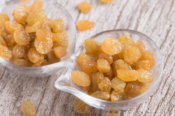 Dried yellow raisin fruits on  wood background