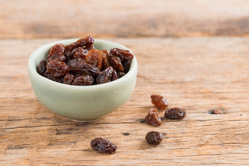 Raisins on a wood background.