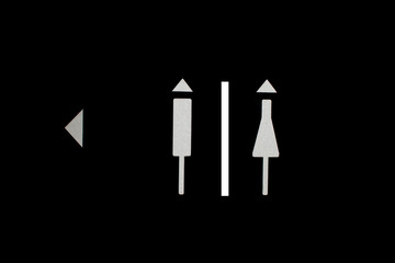 Women and Men Toilet Sign on black background