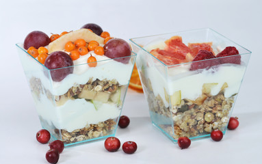 Two homemade granola delicious dessert with yogurt, grapefruit and walnut in a glass jar